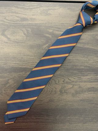 Corbata azul con rayas doradas y rojas