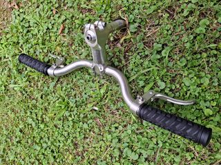 Manillar de bicicleta plateado con puños