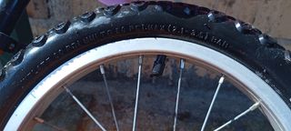 Bicicleta infantil naranja con ruedines