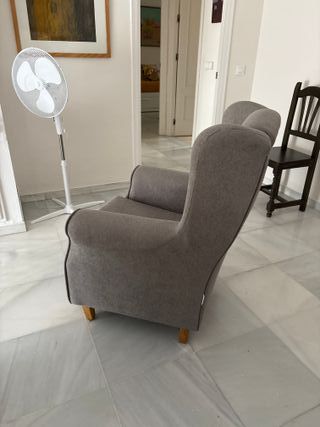 Sillón orejero gris de tela
