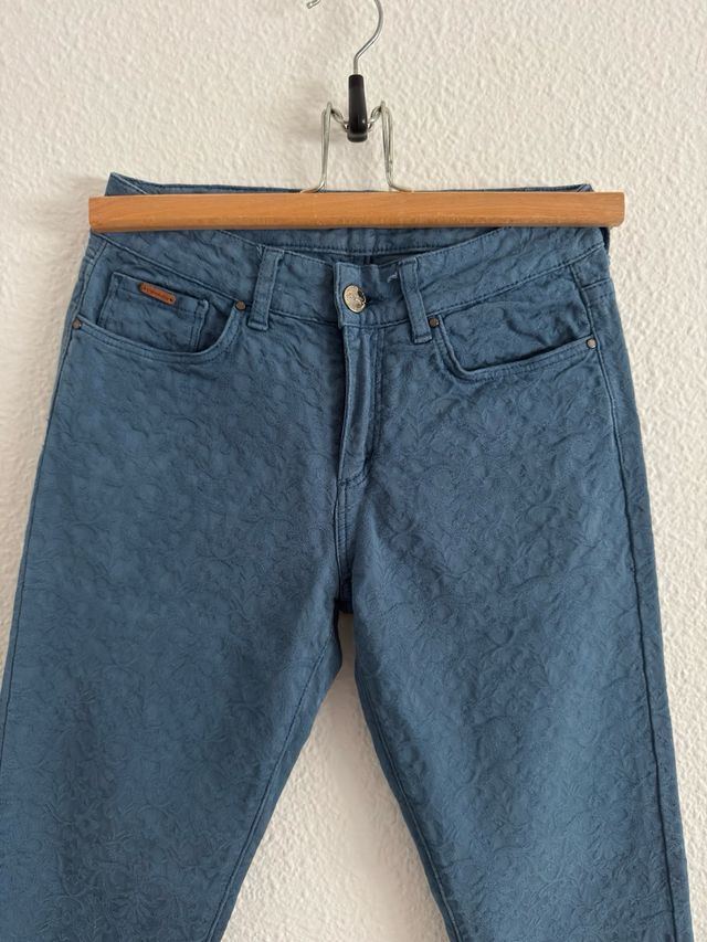 Pantalón vaquero denim con patrón floral.