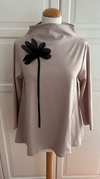 Casaca cuello chimenea beige con broche flor