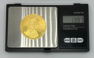 Moneda de oro de 23k, 13.97 g.