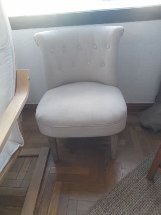 Sillón tapizado beige con patas de madera 