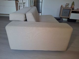 Sofá de tela beige con patas metálicas