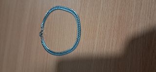Pulsera de acero inoxidable en tono plateado.