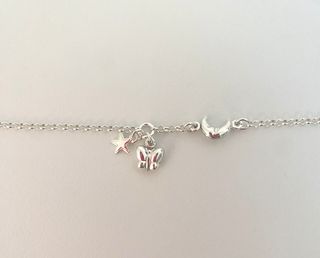 Pulsera plata con mariposa, luna y estrella