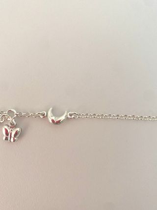 Pulsera plata con mariposa, luna y estrella