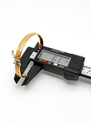Pulsera media caña con tallas de oro 18k