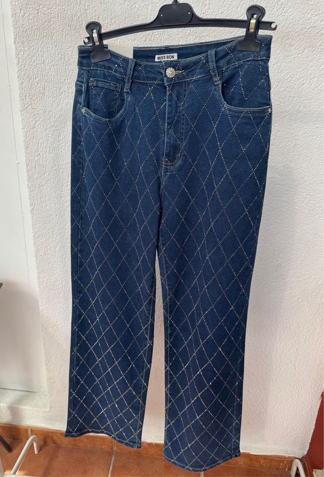 Pantalones vaqueros con brillos dorados