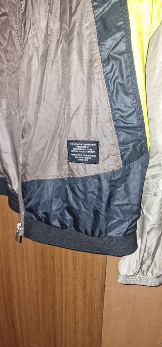 Casaco corta vento Nike unissexo bege e amarelo