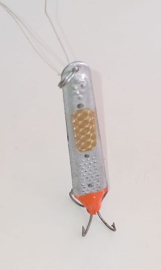 Señuelo de pesca plateado con anzuelos