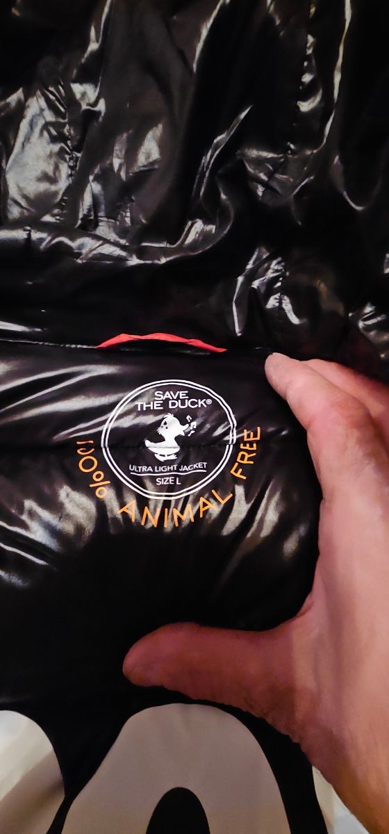 Save the Duck plumífero como naranja metalico