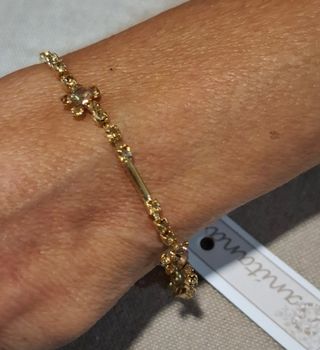 Pulsera dorada con dijes de flor 