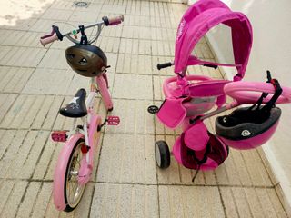 Bicicleta infantil rosa y blanca, y un triciclo 