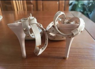 Zapatos de tacón beige con tachuelas doradas