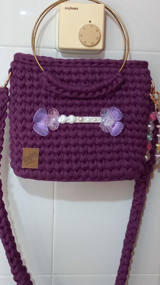Bolso de mano morado con detalles dorados