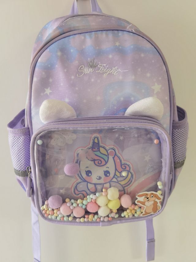 Mochila infantil unicornio con bolsillo transparen