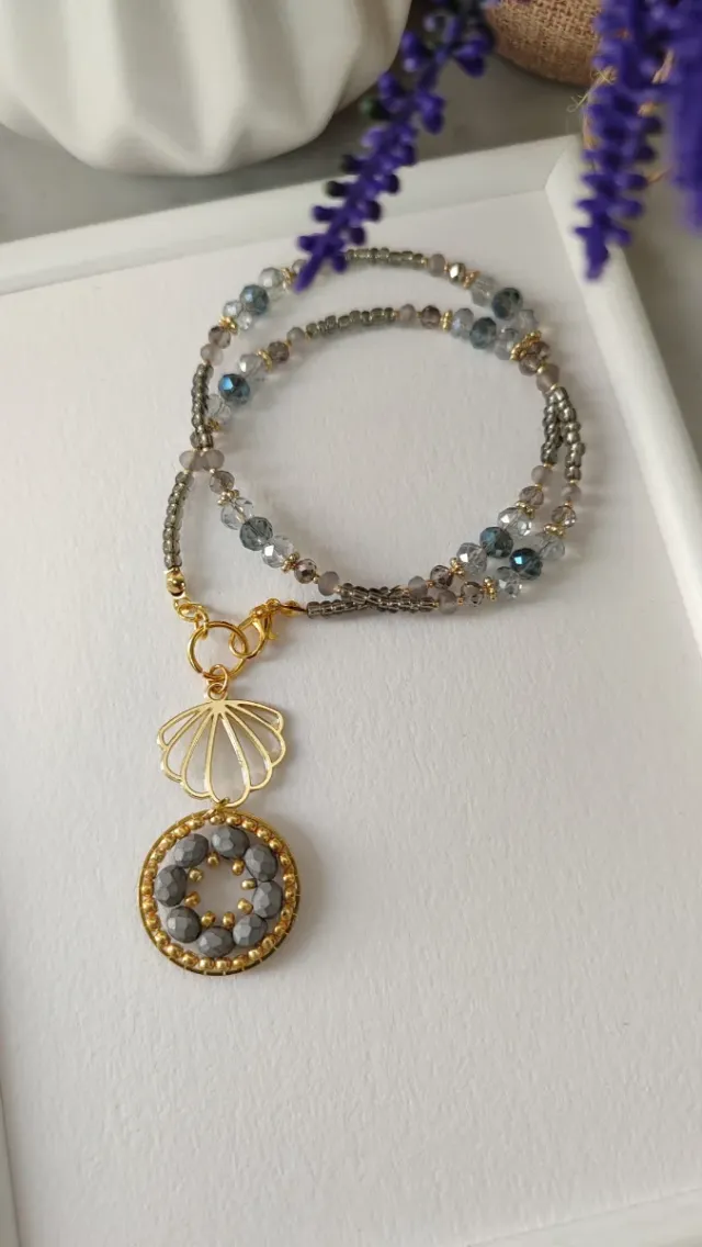 Collana di cristalli in grigio e oro con pendente