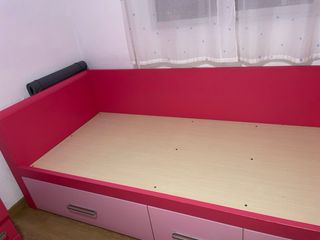 Cama nido rosa con cajones.