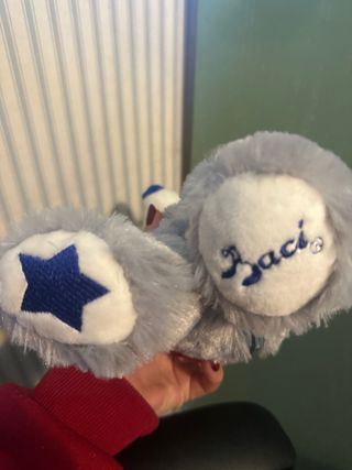 Peluche Trudi grigio con fiocco rosso