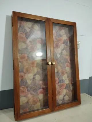 Vitrina pequeña de madera con puertas de cristal. 