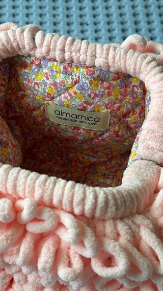 Trendy clutch made of plush pink yarn
