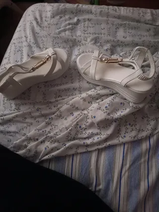 Sandalias blancas con adornos dorados