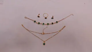 Conjunto de joyas doradas, rojas  y verdes