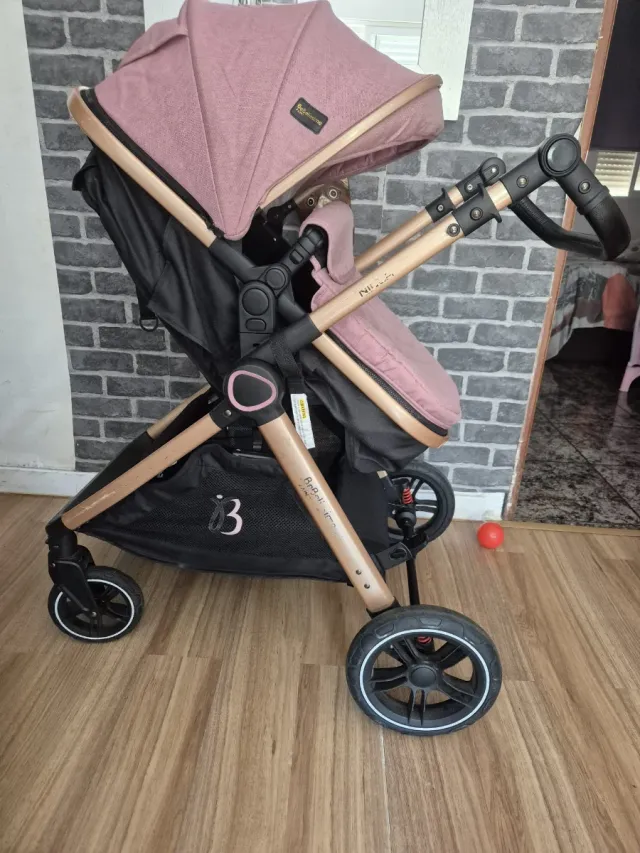 Carrito de bebé rosa y dorado