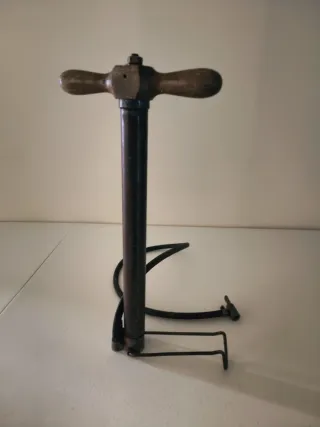 Antigua bomba de inflado, con mango de madera.