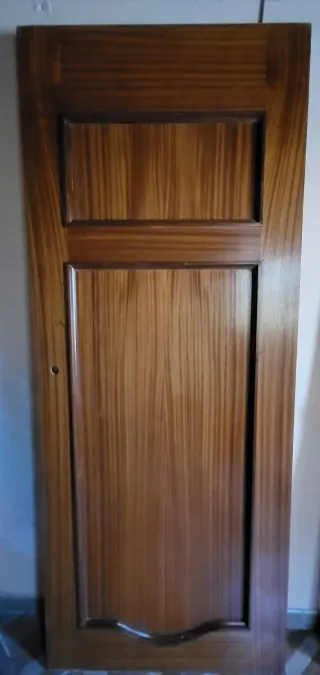 Puertas de madera maciza, una con cristales.
