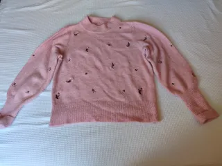 Jersey de punto rosa con bordado.Da bastante talla