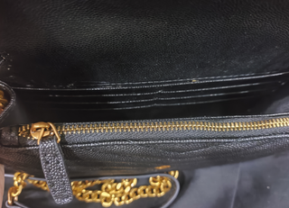 Bolso YSL sobre negro con cadena dorada
