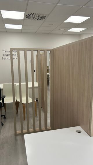 Mesa de oficina blanca con celosía a mediodía.