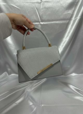 Bolso de mano con brillos y detalles dorados