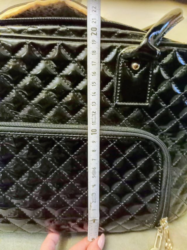 Bolso negro transporting chihuahua.