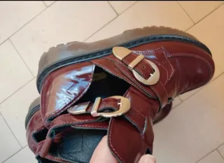 Botines burdeos con hebillas plateadas.