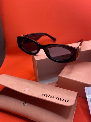 Occhiali da sole Miu Miu neri e oro