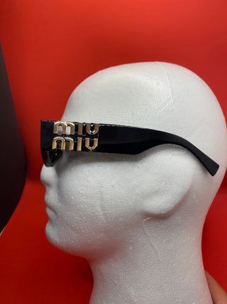 Occhiali da sole Miu Miu neri e oro