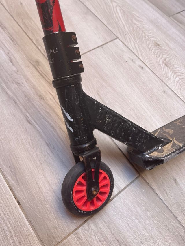 Patinete rojo con ruedas negras