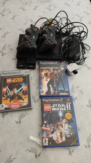 Consola PlayStation 2 con 2 mandos y juegos