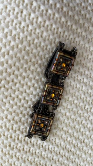 Pulsera de bisutería dorada y cobriza