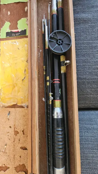 Caja antigua con cañas de pesca vintage