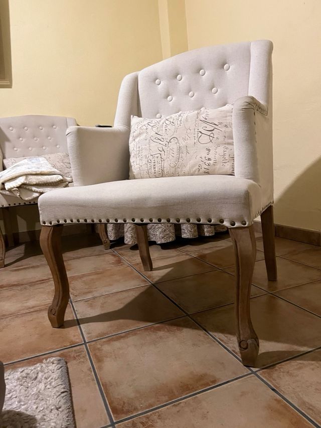 Sillón de tela beige con patas de madera