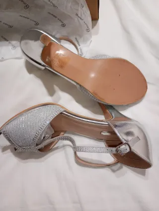 Zapatos de fiesta plateados y bolso a juego.