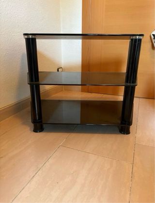 Mesa de cristal negra con detalles dorados