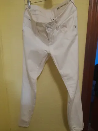 Conjunto de camisa negra y pantalón blanco.