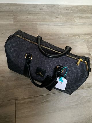 Bolsa de viaje Jordan negra y dorada