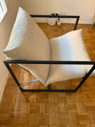 Poltrona singola in grigio con ferro nero. 
